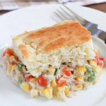 Rectangular piece of biscuit with mixed vegetables and shredded chicken in a white sauce